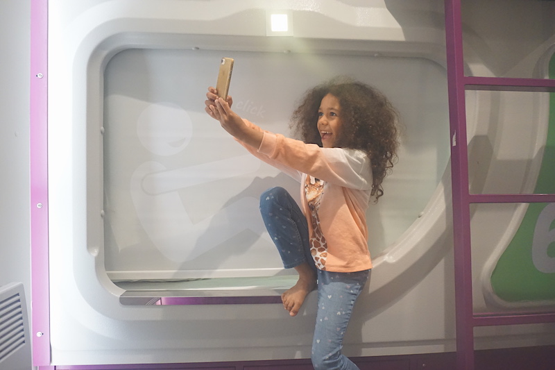 Girl takes a selfie in front of the Jucy Snooze Pods
